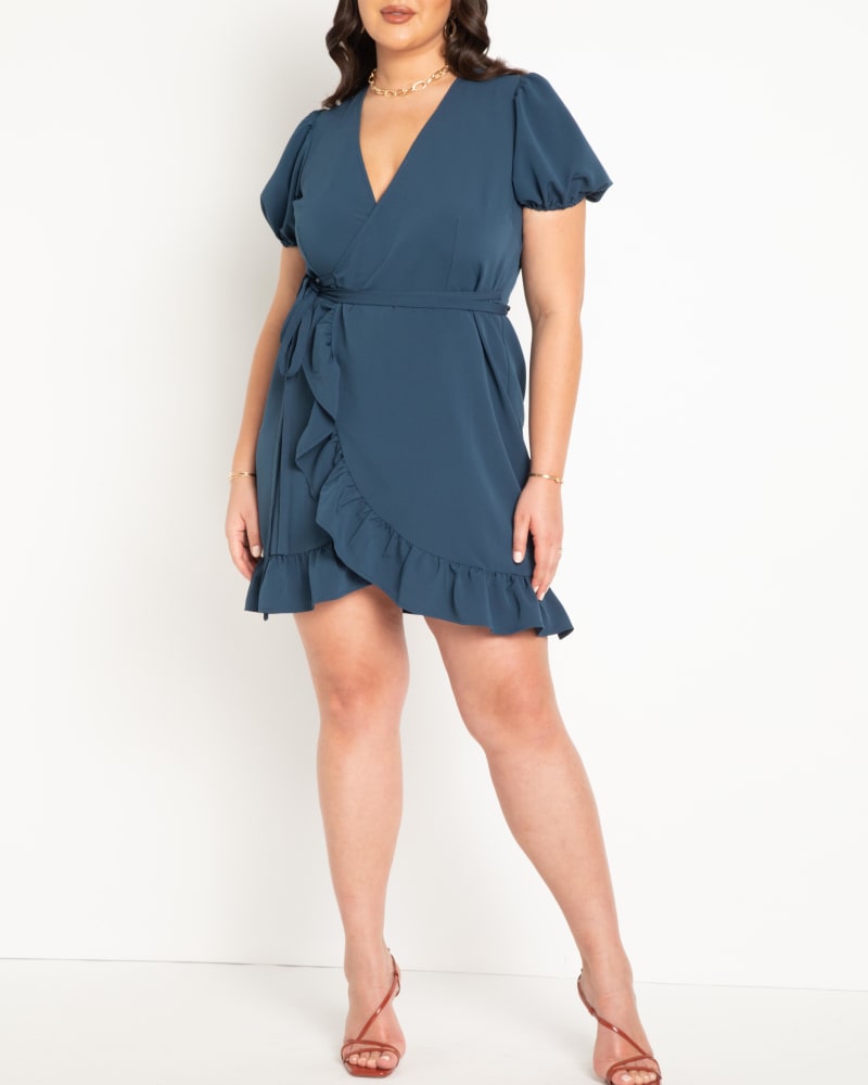 Front of a model wearing a size 24 Woven Mini Wrap Dress in Moonlit Ocean by ELOQUII. | dia_product_style_image_id:294145